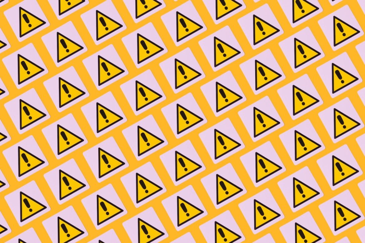 yellow warning symbols with exclamation points on a patterned background